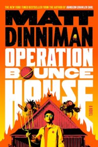 The cover has a man wearing sunglasses and holding a pitchfork. Behind him is a burning building with two strange robots on top of it.