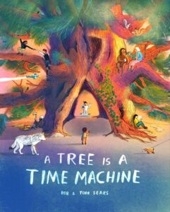 The cover has an illustration of a big tree people are living in. People are inside and sitting on the branches. A boy stands in front of a tree next to a wolf.