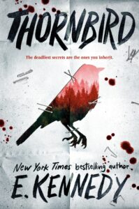 the cover has an photo of a forest in shades of red that is cut in the shape of a bird. It is stapled to a page with blood splatter on it.