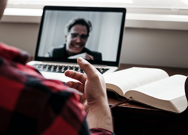 image of someone engaging with another via laptop computer