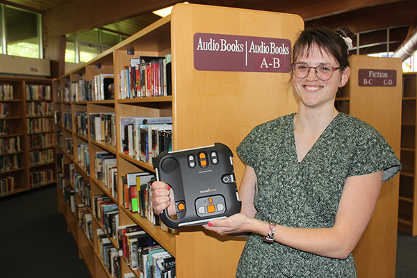 Librarian holds a DAISY reader