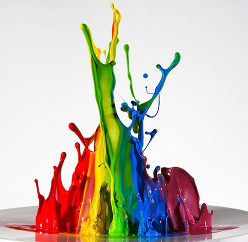 image of rainbow-coloured paint splashing together.