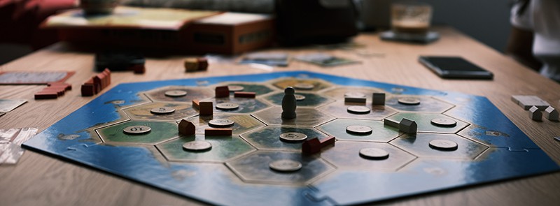 photo of the board game Catan showing playing pieces on the game board.