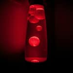 image of a lava lamp filled with bubbles in red lighting