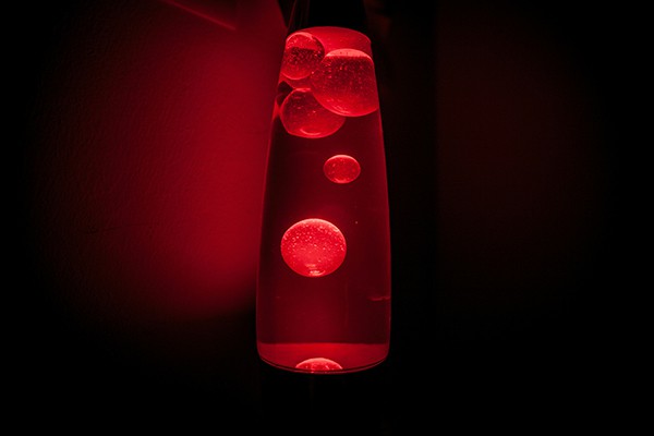 image of a lava lamp filled with bubbles in red lighting