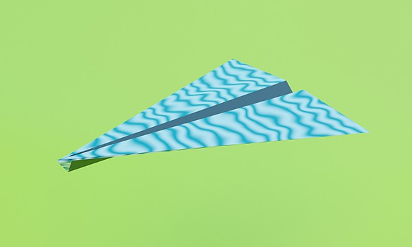 image of blue and white coloured paper airplane on green background
