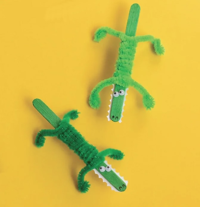 image of two green crocodiles made out of popsicle sticks and pipe cleaners.