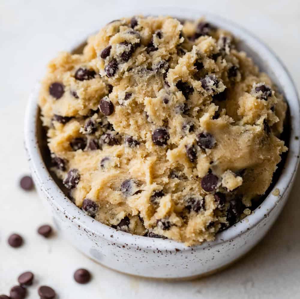 light brown edible cookie dough with chocolate chips in a white bowl