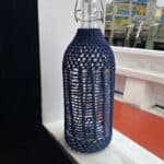 bottle with hitched rope around it