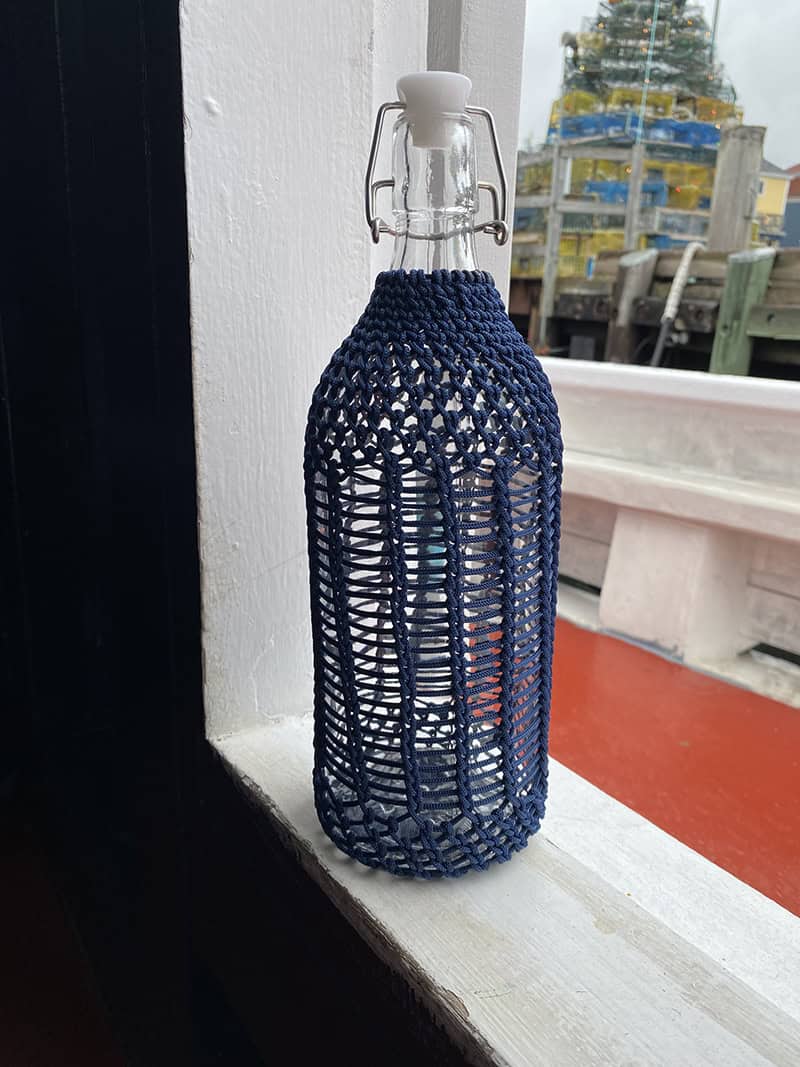 bottle with hitched rope around it