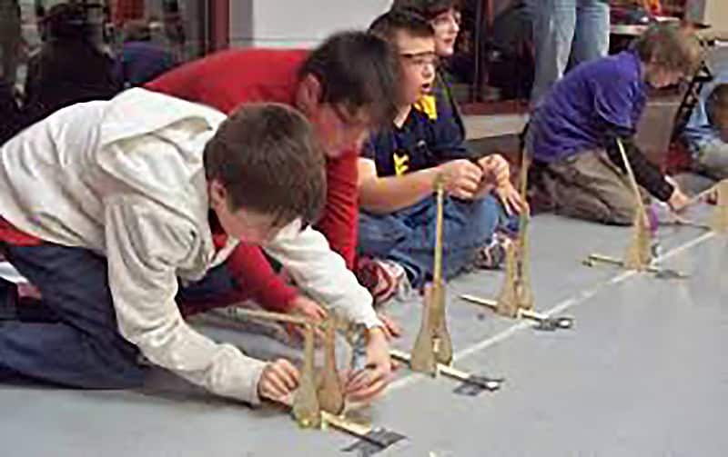 children operating mini-catapults