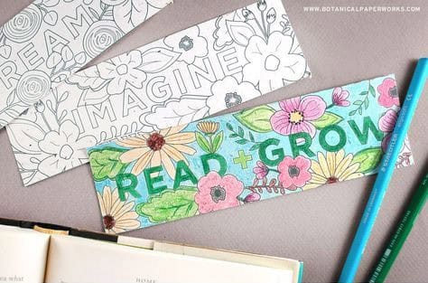 Three types of bookmarks with one coloured in by coloured pencils, two coloured pencils and a book