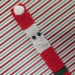 paint stick red Santa made with yarn.