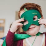 boy wearing a costume with a mask