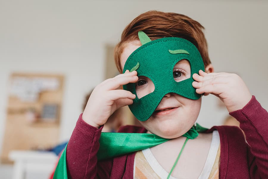 boy wearing a costume with a mask