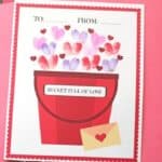 image of a Valentine card with a bucket being filled with thumbprint hearts and the text 'To: From: Bucket Full of Love'