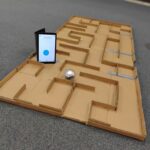 image of a tablet and a spherical robot in a maze