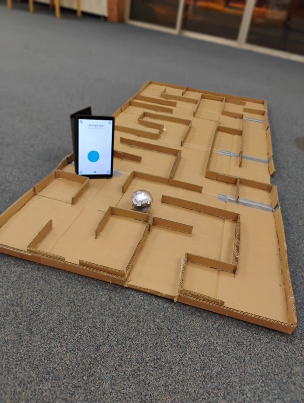 image of a tablet and a spherical robot in a maze