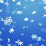 snowflakes falling against a blue sky