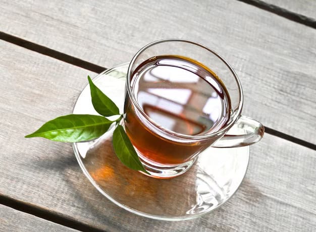 clear glass up of tea with herbal sprig on the side