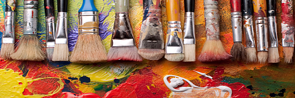 image of a row of paint brushes of various sizes on a painted canvas.