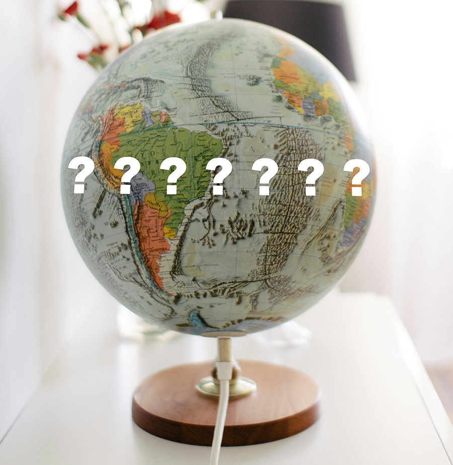 image of a globe with white question marks on it.