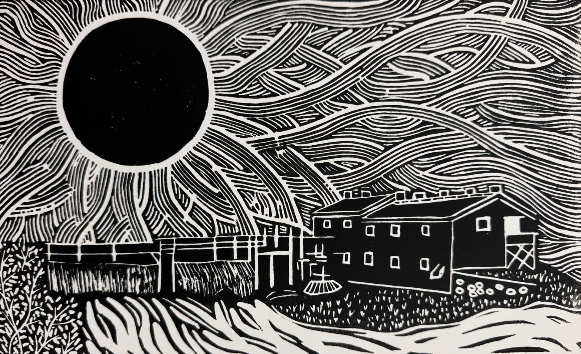 image of a linocut featuring a large sun over two buildings by a river.