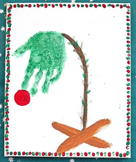 image of a droopy Christmas tree on a stand with one red decoration.