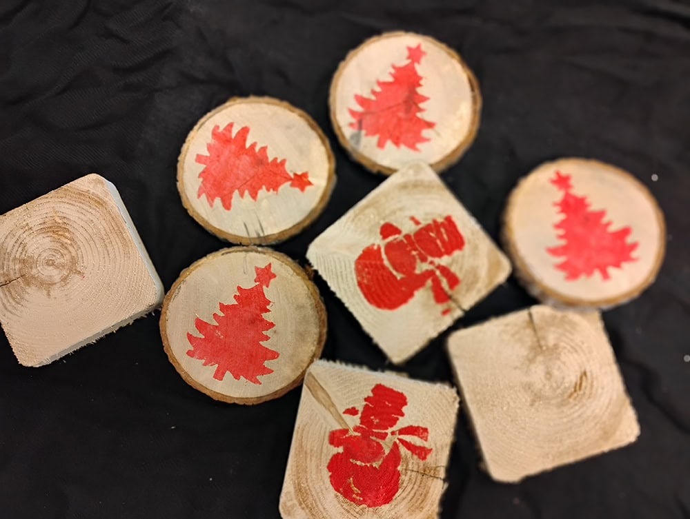image of wooden coasters with red Christmas stamps on them