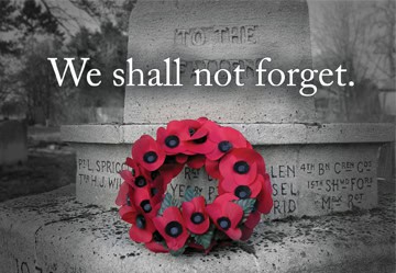 image of a red poppy wreath at the base of a cenotaph.