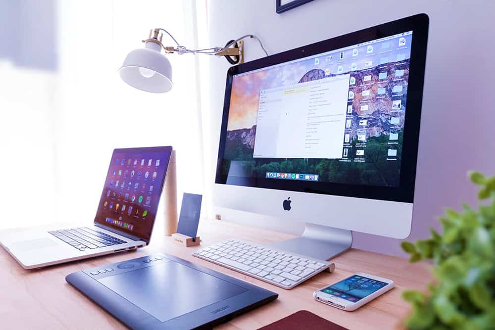 image of a desktop computer, laptop, tablet and smartphone.