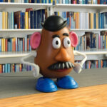 image of Mr. Potato Head in front of a book shelf.