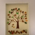 image of a fall tree made of sea glass in a frame.