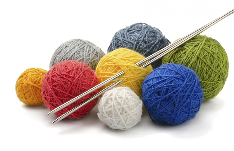image of coloured balls of yarn and knitting needles