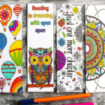 Paper bookmarks with an owl, hot air balloons, mandalas on them. They are coloured in by markers.