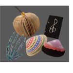 Various crafts are displayed. There is a pumpkin made from a book, a skeleton hand, painted seashells, and a treble clef notebook.