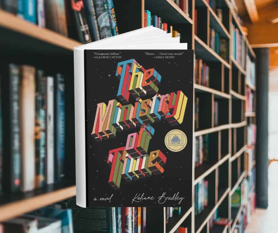 The cover features the title in 3d printed letters. The letters are all different colours. The background is black with small white dots that look like stars in space. Behind the cover are shelves of books.