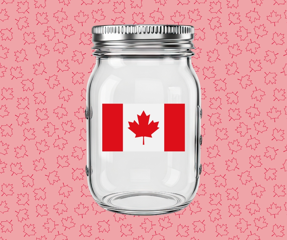 An empty mason jar with the Canadian flag on it. The background is red with lots of tiny maple leaves.
