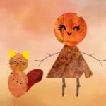 An art project of a girl and a cat made out of cut up leaves. The girl has twigs for arms and legs.